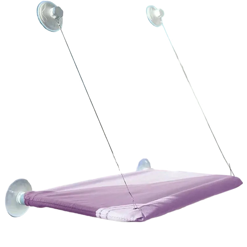 The hammock in purple, mounted on a window