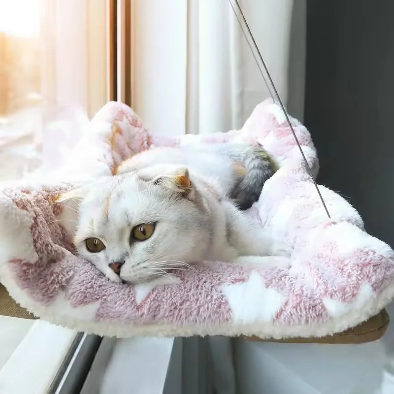A white cat asleep on the hammock with a fleece cushion