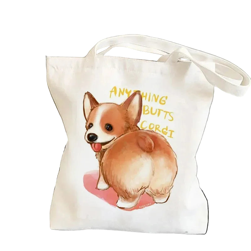 Cream canvas tote bag featuring a cartoon Corgi from behind with the phrase Anything Butts Corgi