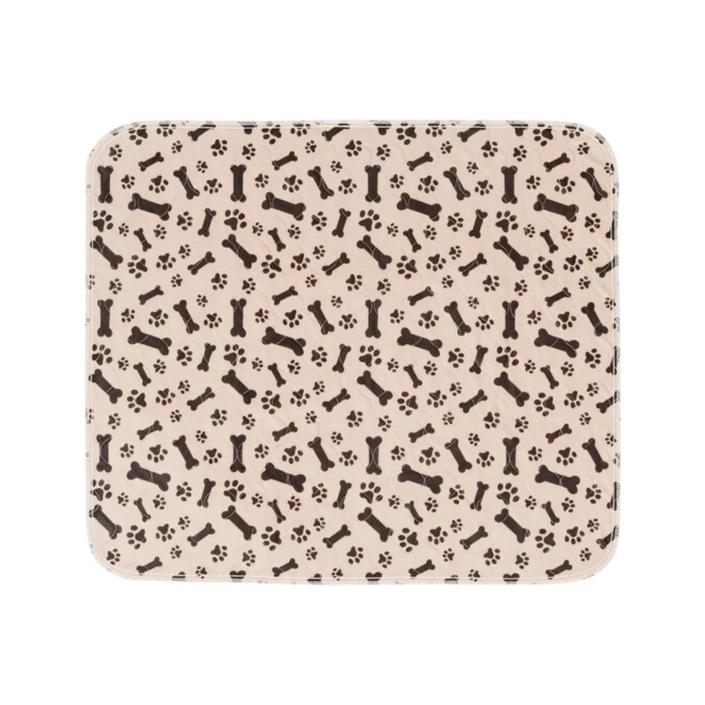 Beige rectangular dog bed mat with black bone and paw print pattern and rounded corners