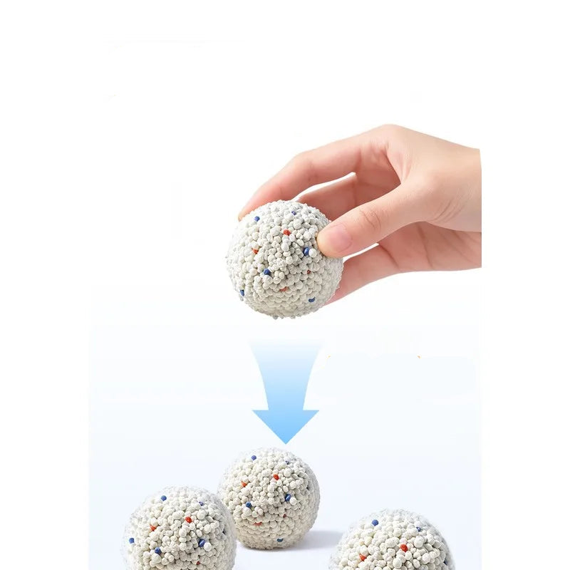 Hand holding a clump of bentonite cat litter showing fast clumping and moisture absorption