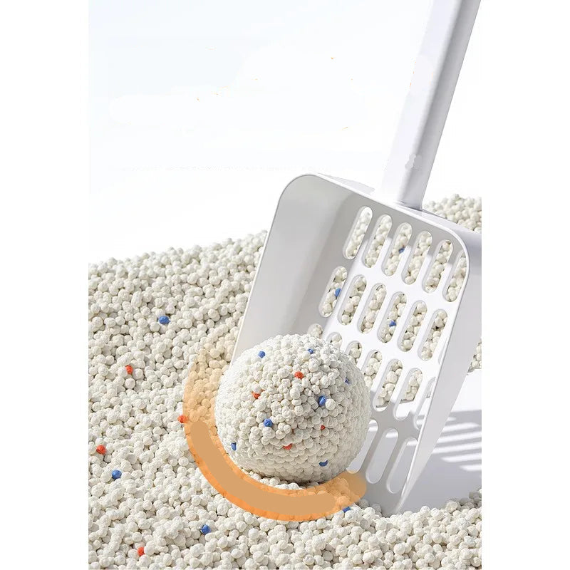 Cat litter scoop lifting a firm clump of bentonite cat litter for easy waste removal