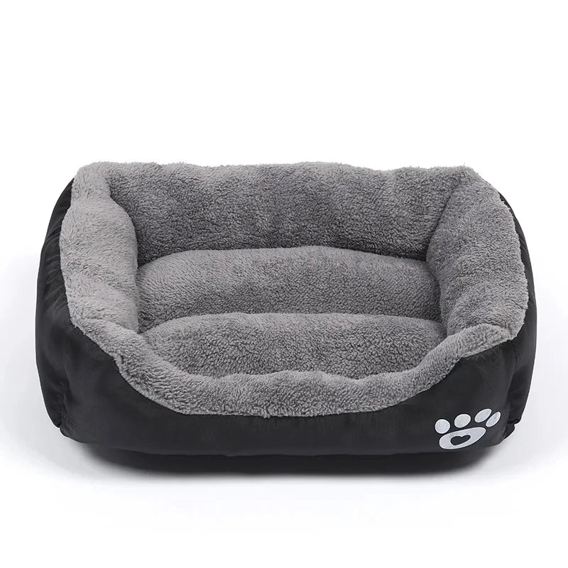 Black and grey plush bolster dog bed with soft padded base, raised cushioned sides and paw print detail