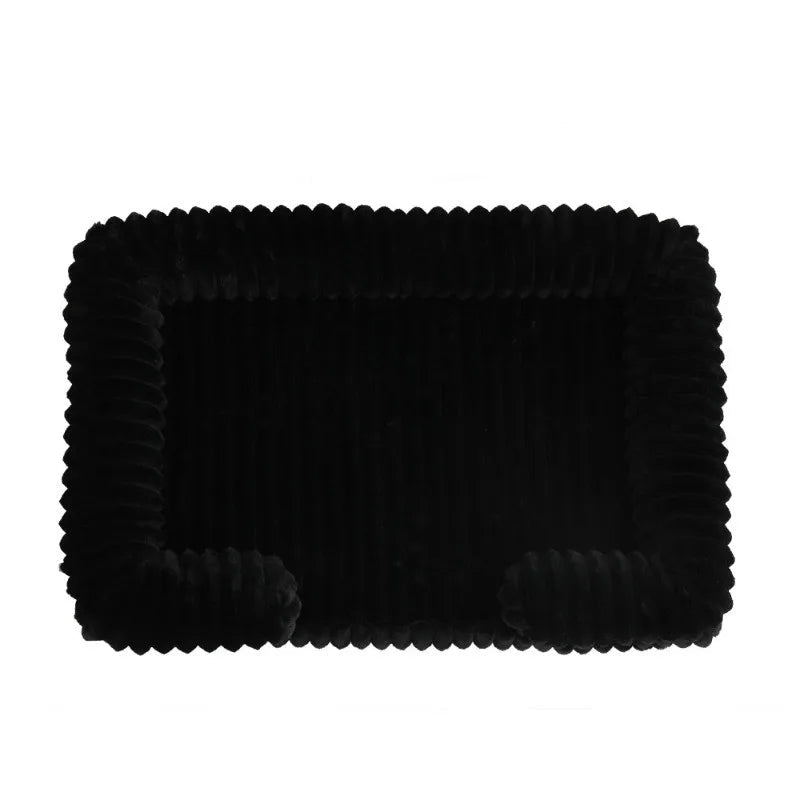 Black ribbed dog bed mat with soft padded surface and raised cushioned sides