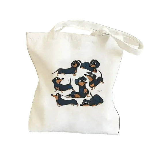 Cream canvas tote bag featuring two Dachshunds forming a heart shape around a red heart graphic