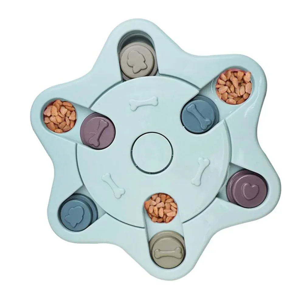 Blue star-shaped interactive dog puzzle feeder with sliding treat compartments filled with dry dog food