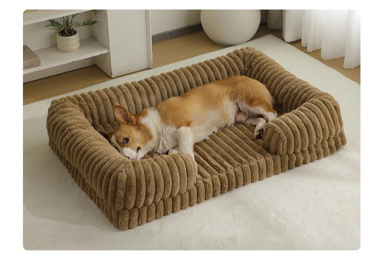 Corgi resting on a brown ribbed dog bed with soft padded base and raised bolster sides