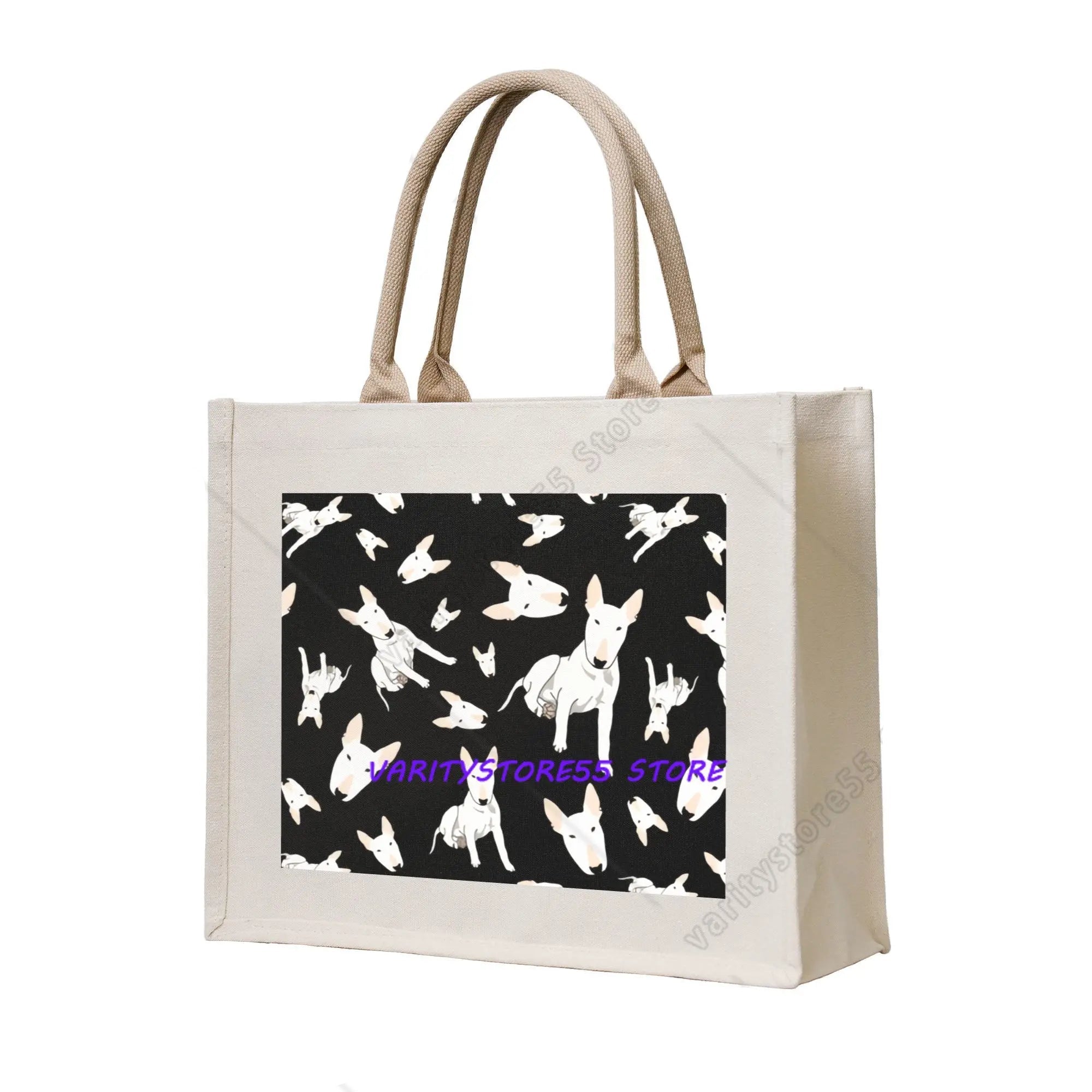 Cream canvas tote bag featuring multiple white Bull Terrier illustrations on a black patterned background