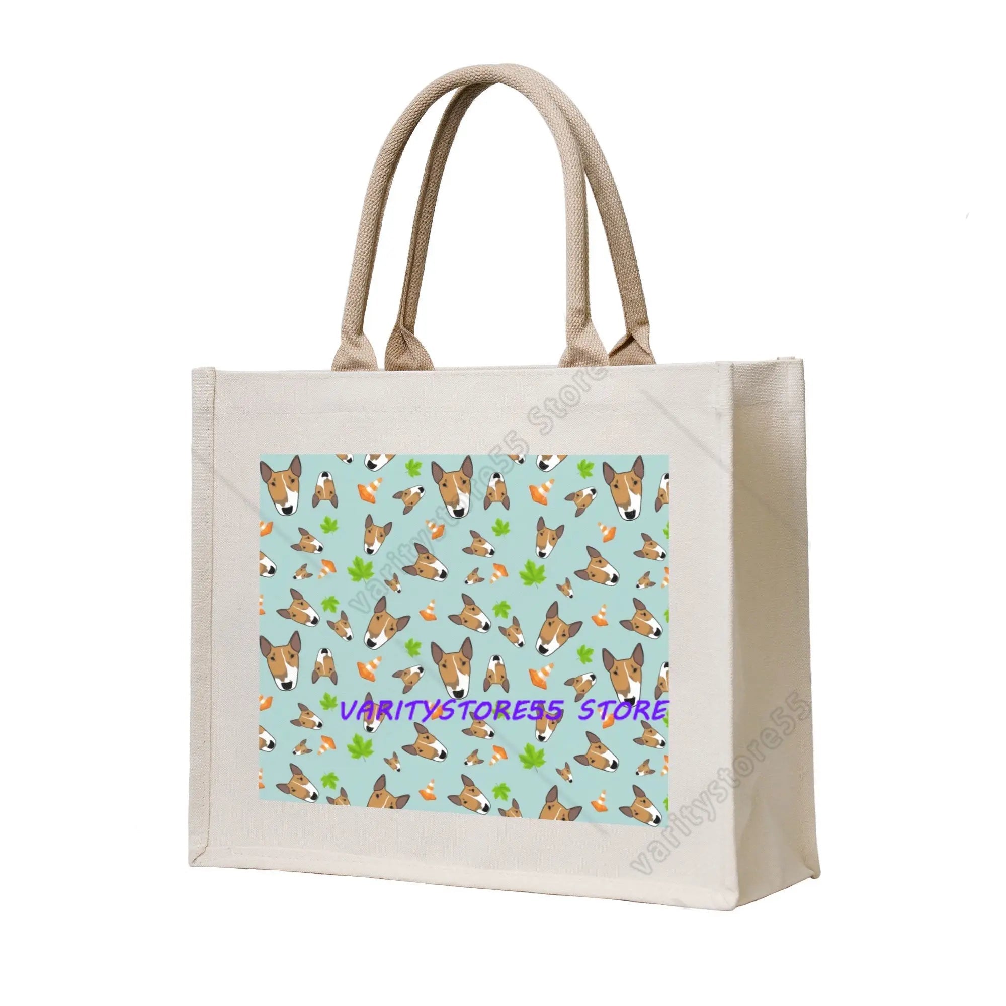 Cream canvas tote bag featuring a blue pattern with Bull Terrier illustrations, carrots and green leaves