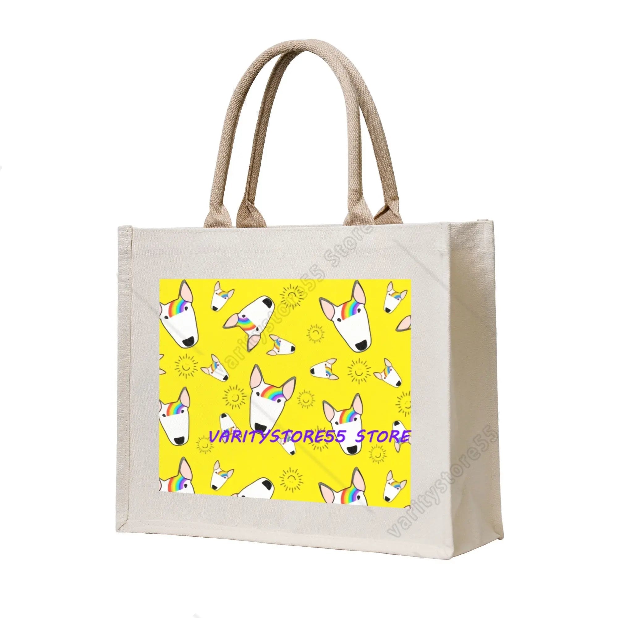 Cream canvas tote bag featuring Bull Terrier faces with rainbow accents on a bright yellow patterned background