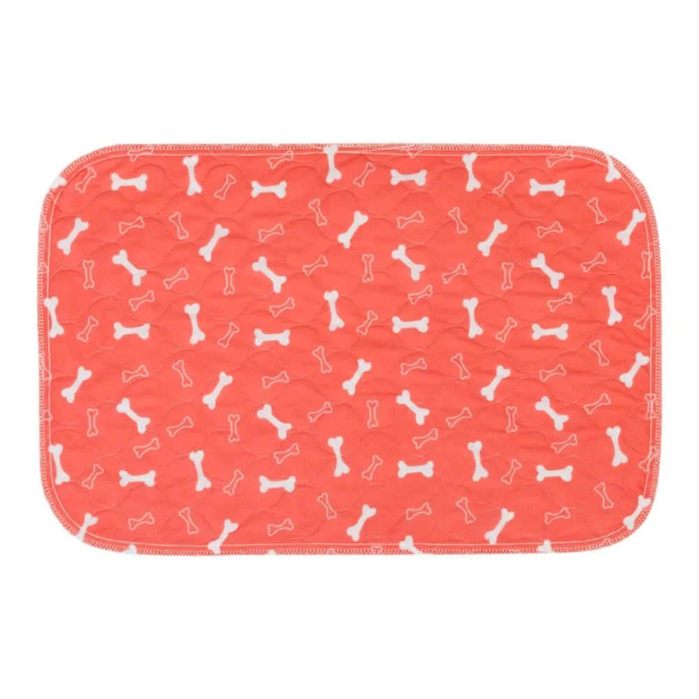 Coral quilted dog bed mat with white bone pattern, padded surface and rounded corners
