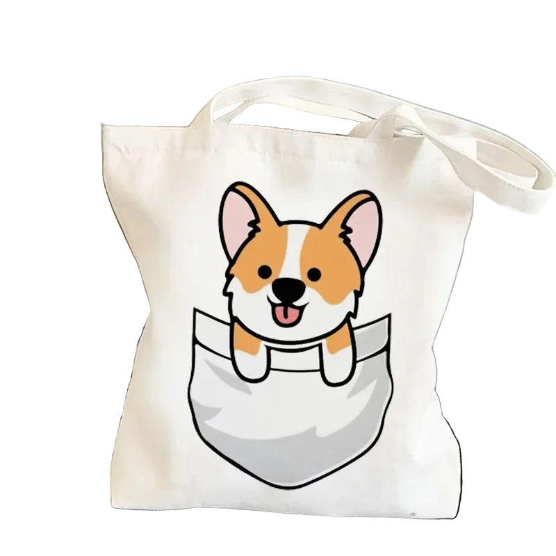 Cream canvas tote bag featuring a cute cartoon Corgi peeking out of a pocket