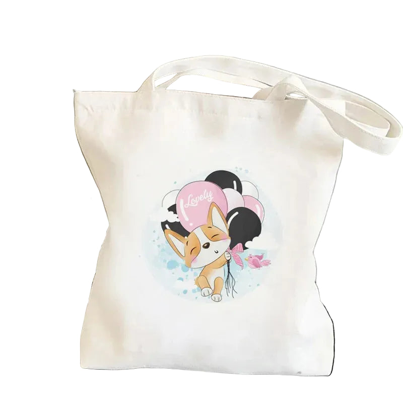 Cream canvas tote bag featuring a cute Corgi holding pink and black balloons with a Lovely graphic