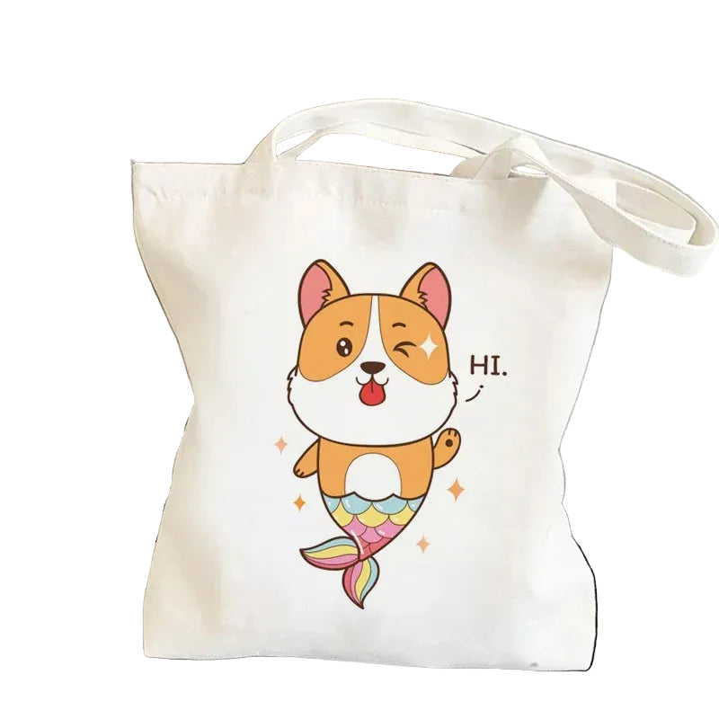 Cream canvas tote bag featuring a cute cartoon Corgi with a colourful mermaid tail and the word Hi