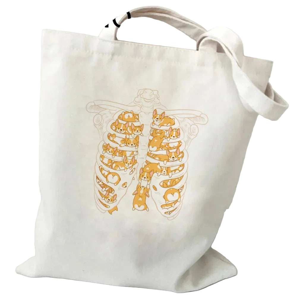 Cream canvas tote bag featuring a ribcage illustration filled with playful Corgis