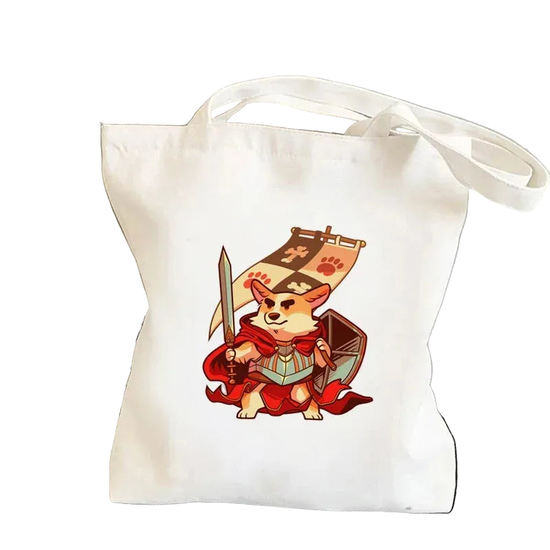 Cream canvas tote bag featuring a cartoon Corgi warrior holding a sword and shield with a red cape