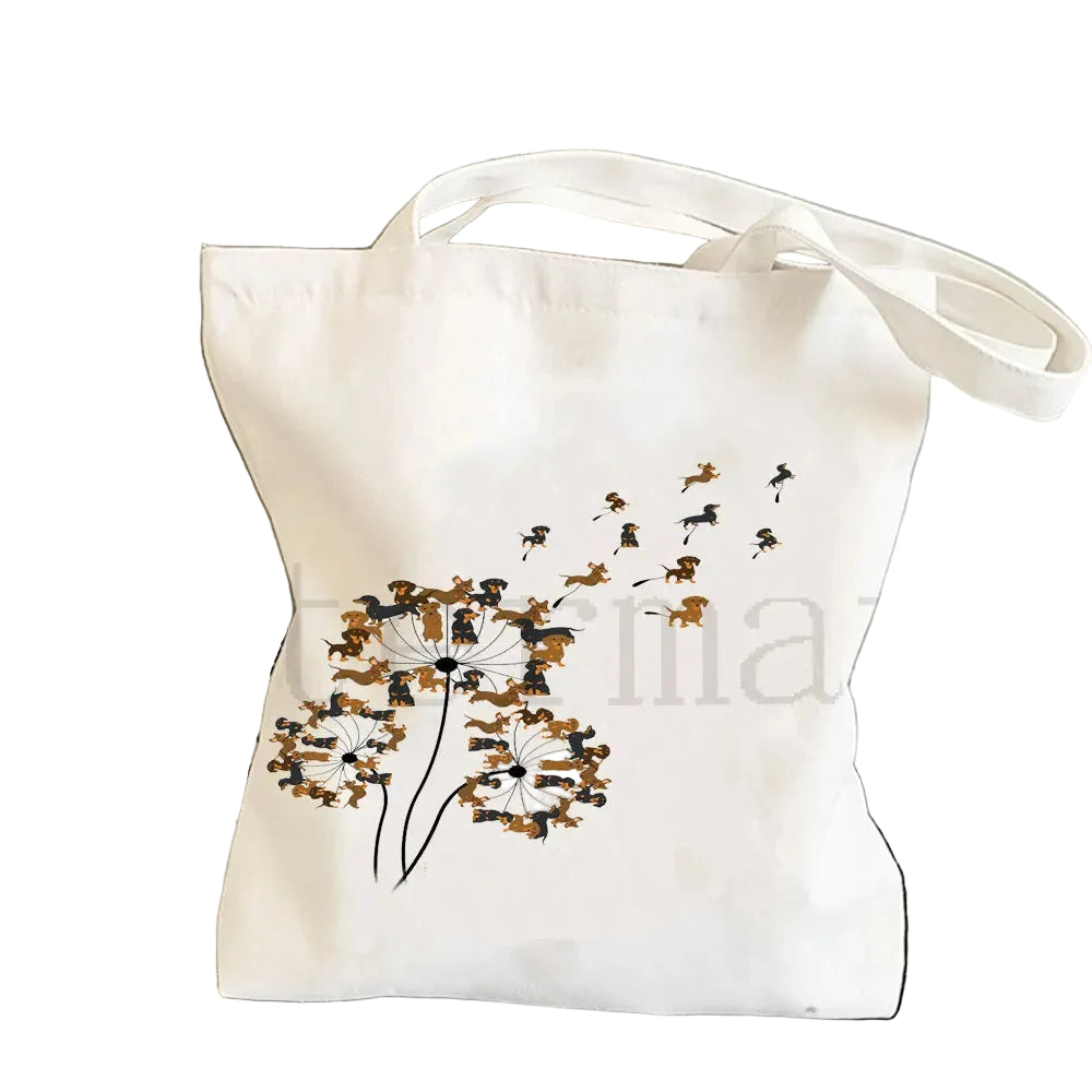 Cream canvas tote bag featuring a dandelion-style illustration made from small Dachshund dogs