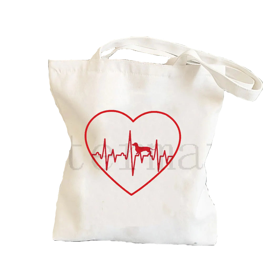 Cream canvas tote bag featuring a red heart and heartbeat line with a Dachshund silhouette