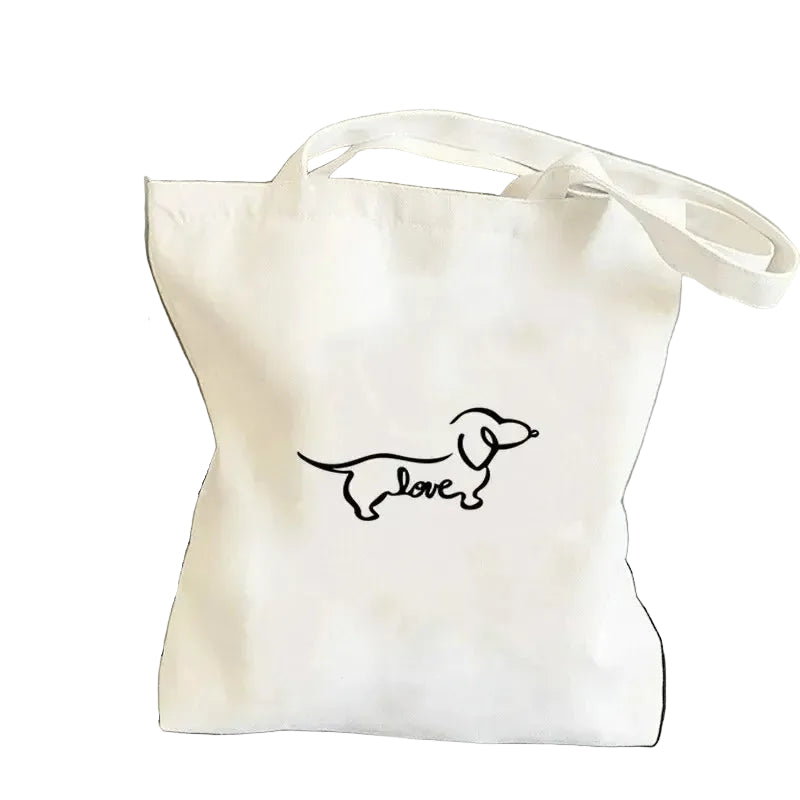 Cream canvas tote bag featuring a minimalist Dachshund line drawing with the word Love