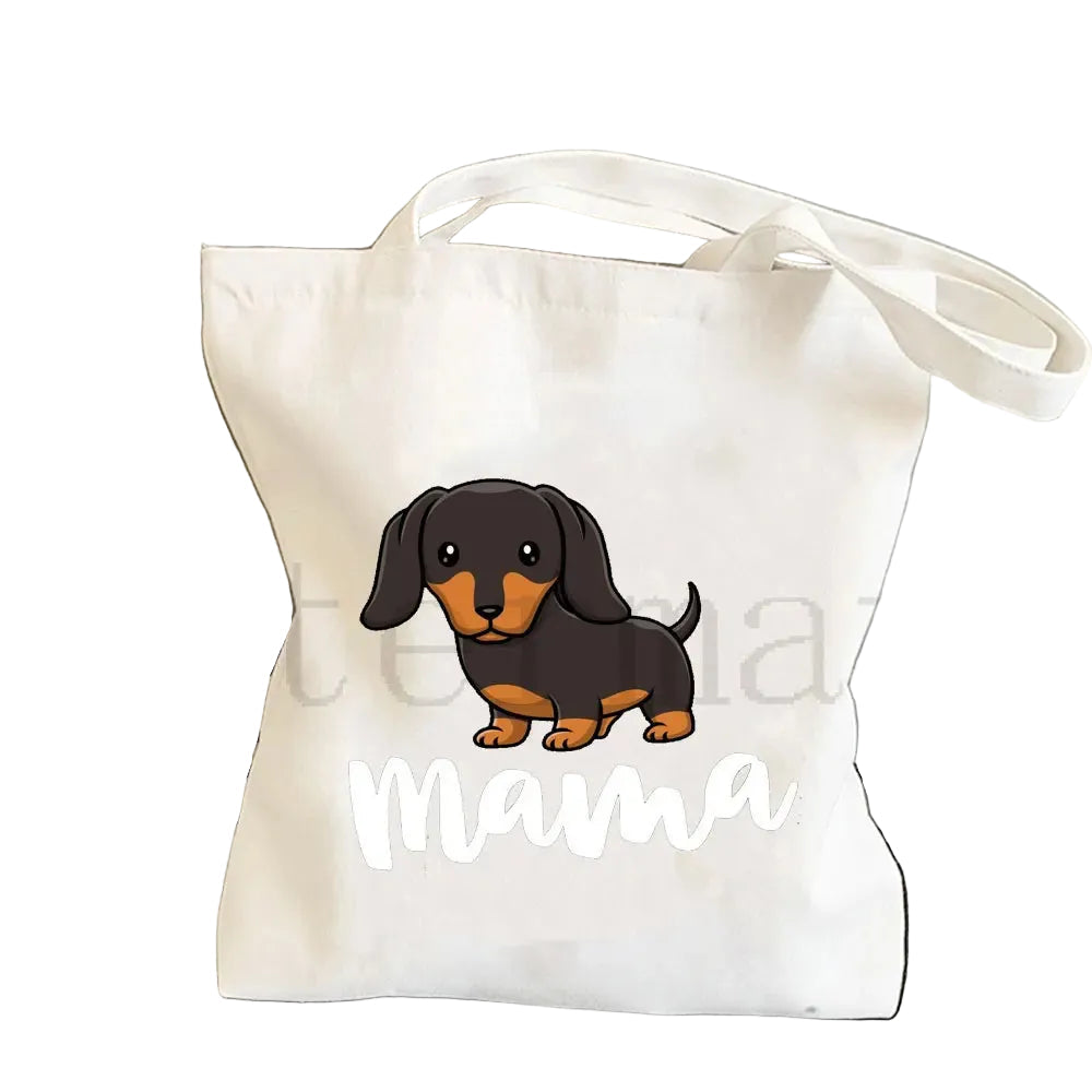 Cream canvas tote bag featuring a black and tan cartoon Dachshund with the word Mama