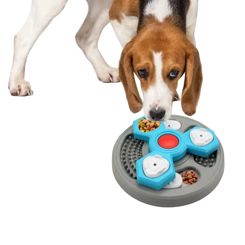 Dog eating from a rotating interactive puzzle feeder with hidden treat compartments and dry dog food.