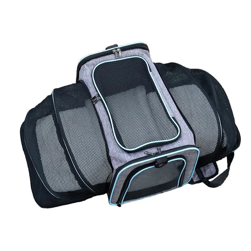 Top view of a grey expandable pet carrier with large breathable mesh panels, zippered openings and blue trim