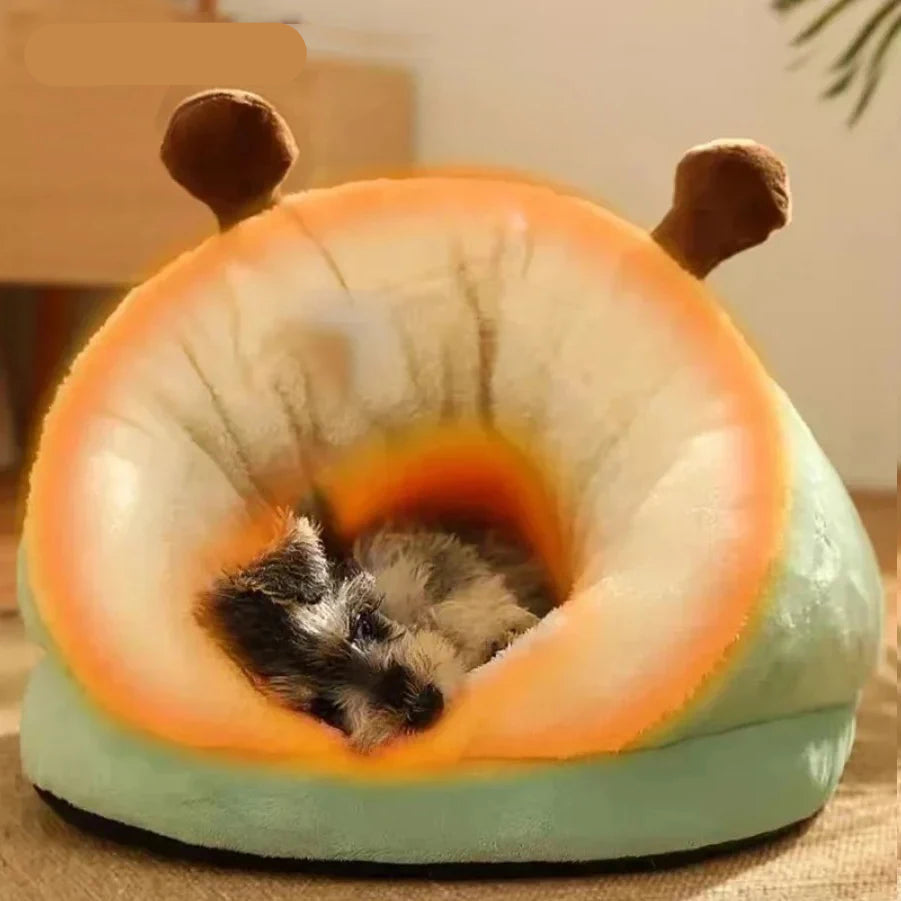 Small dog sleeping inside a green and orange plush covered pet bed with soft cushioned lining