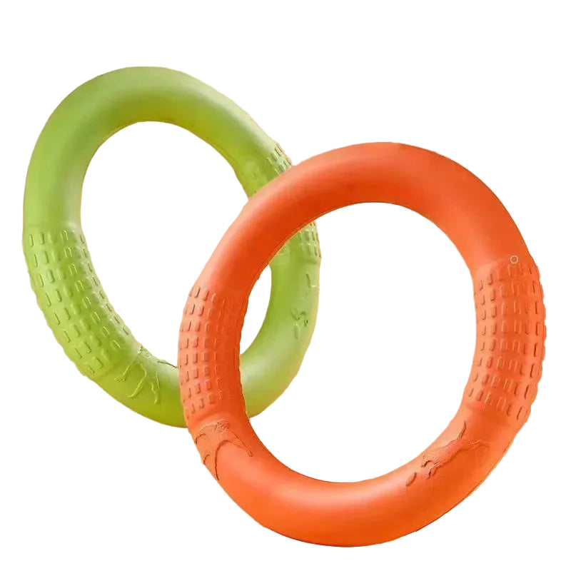 Green and orange ring-shaped dog chew toys with textured grip sections