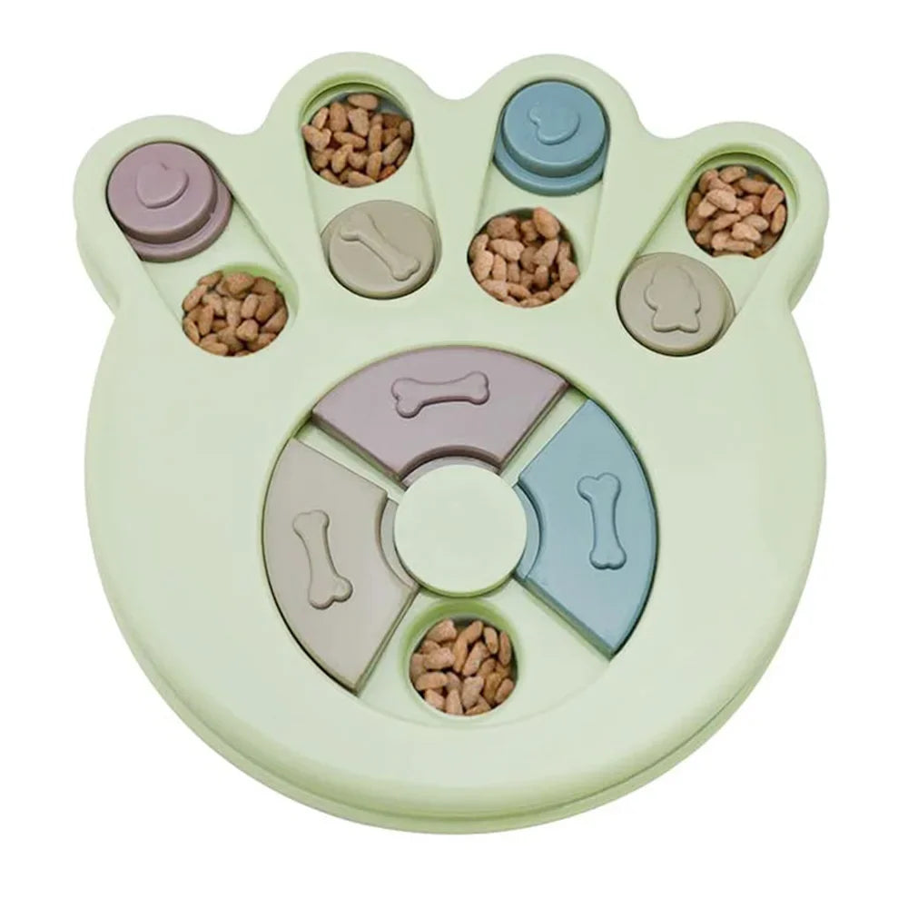 Green paw-shaped interactive dog puzzle feeder with sliding treat compartments filled with dry dog food