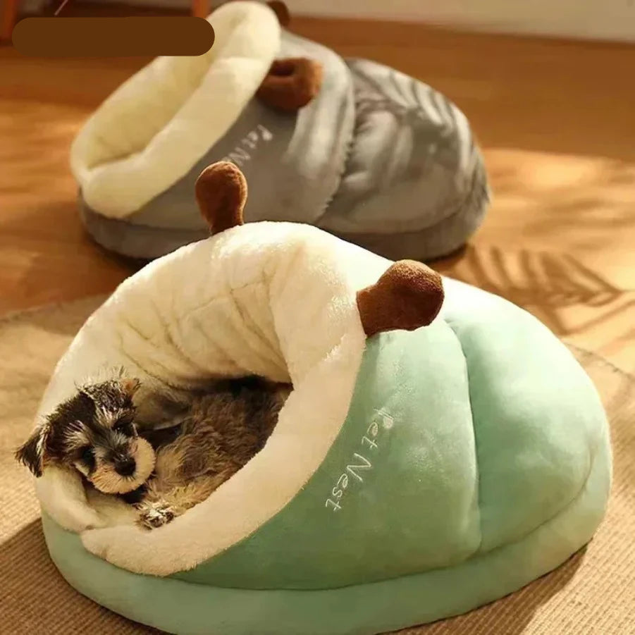 Small dog resting inside a green plush covered pet bed with soft cream lining and a grey colour option in the background