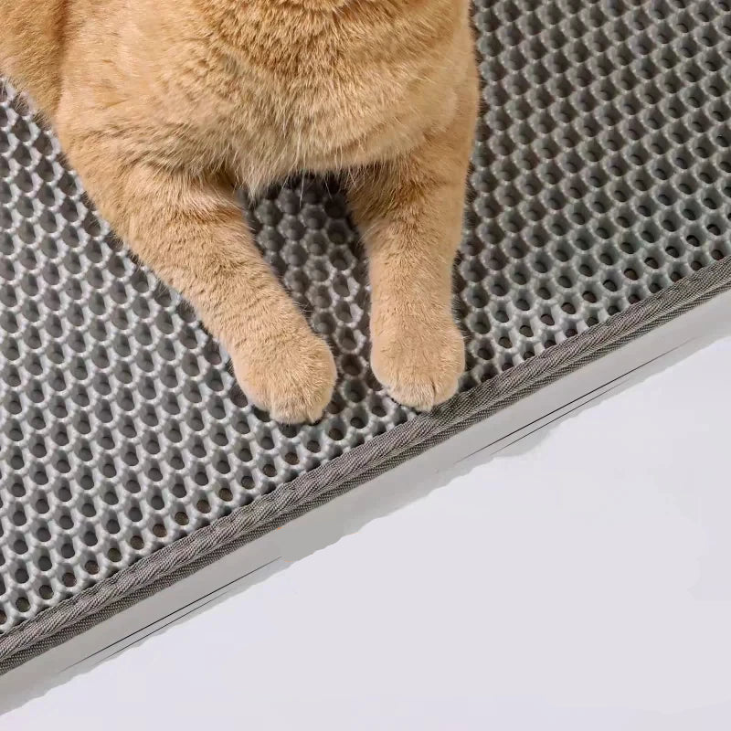 Brown rectangular pet mat with textured honeycomb surface and rounded corners