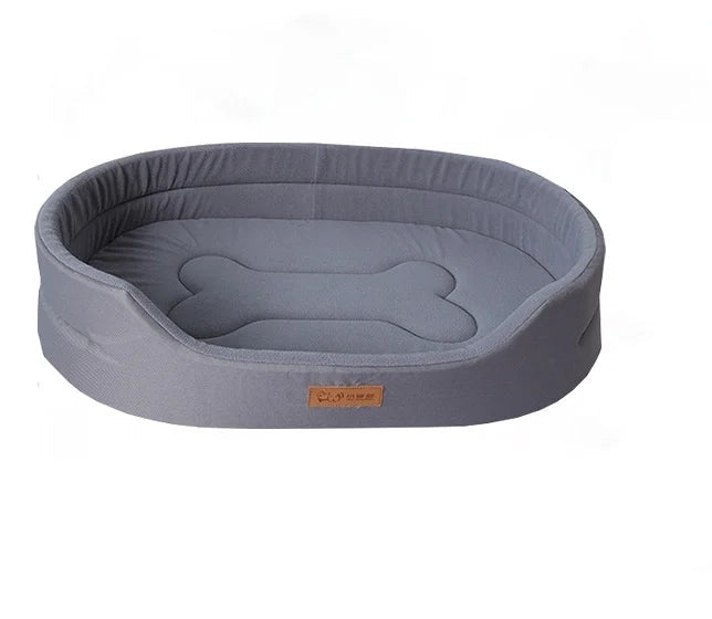 Grey oval dog bed with raised padded sides, low front entry and a bone-shaped cushion design