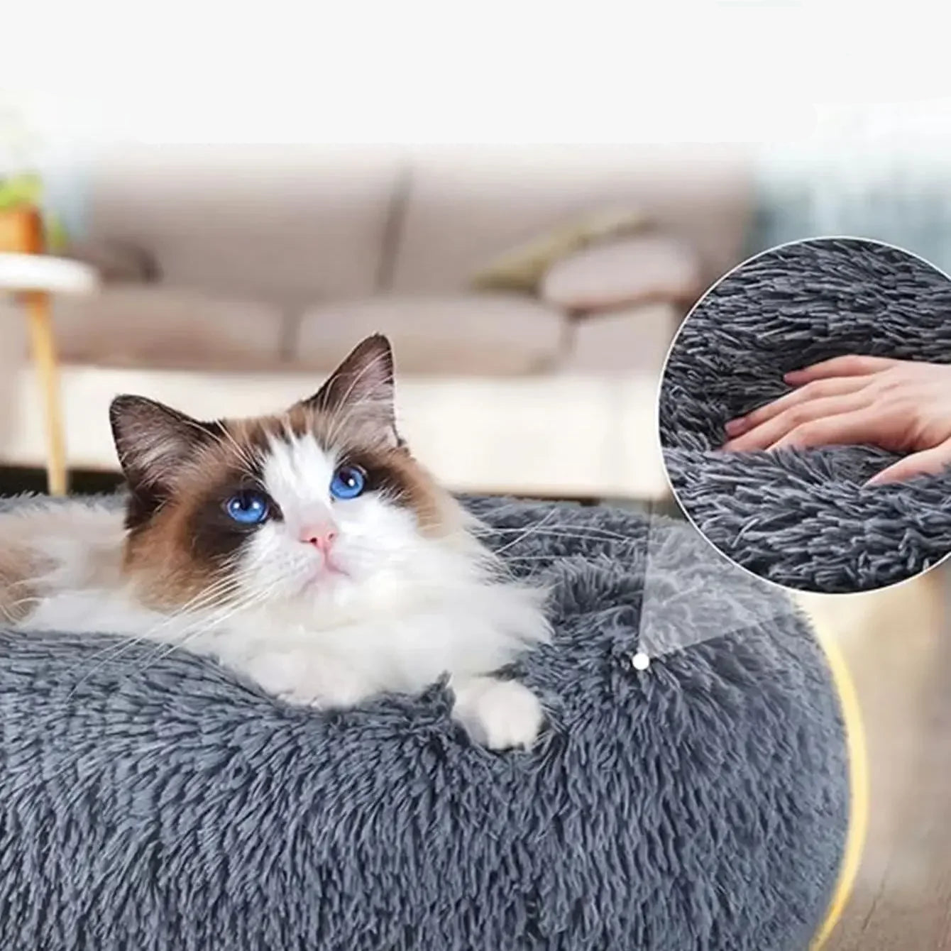 Fluffy cat resting in a grey plush donut cat bed with soft faux fur and raised cushioned sides