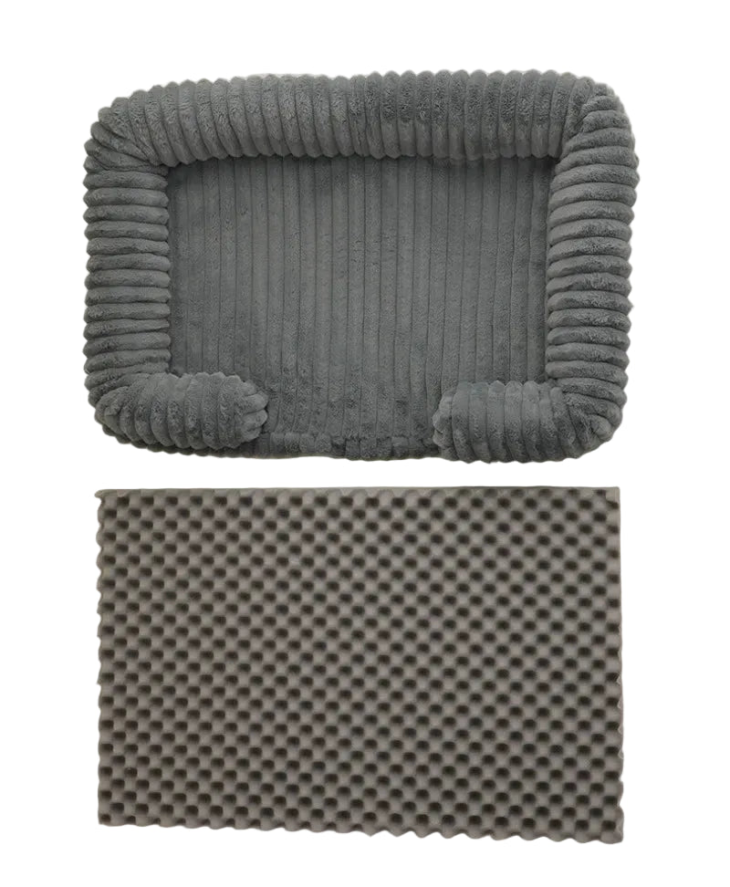 Grey ribbed dog bed with raised bolster sides and removable egg crate foam base for added support