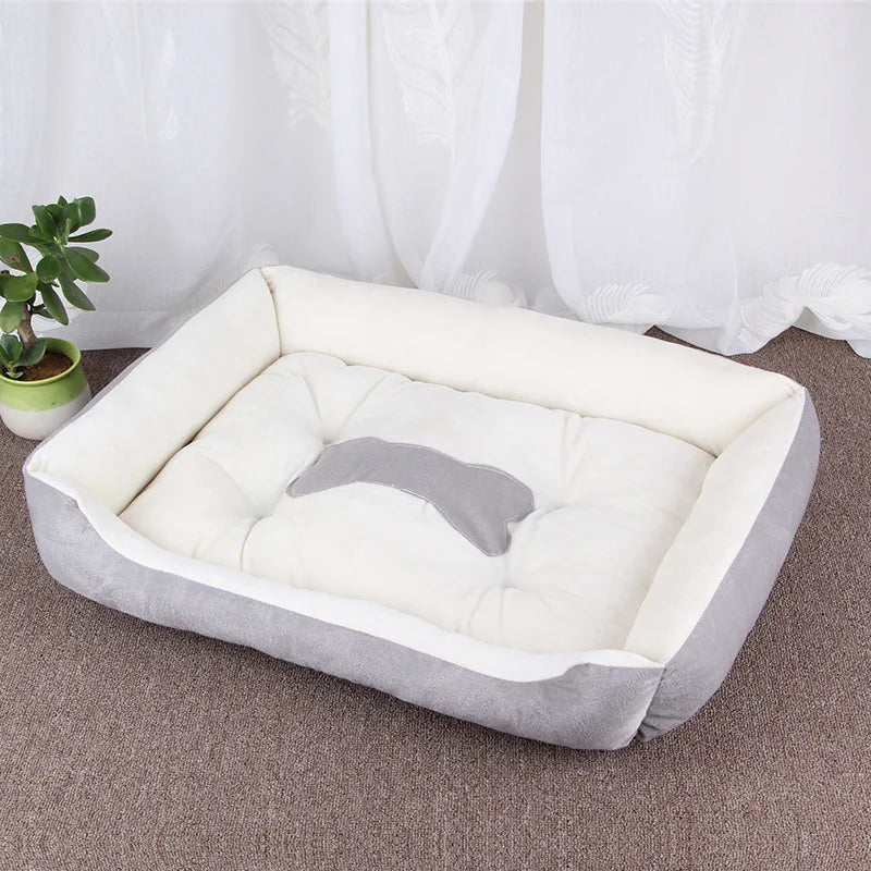 Grey and white plush bolster dog bed with padded base, raised cushioned sides and bone-shaped centre detail