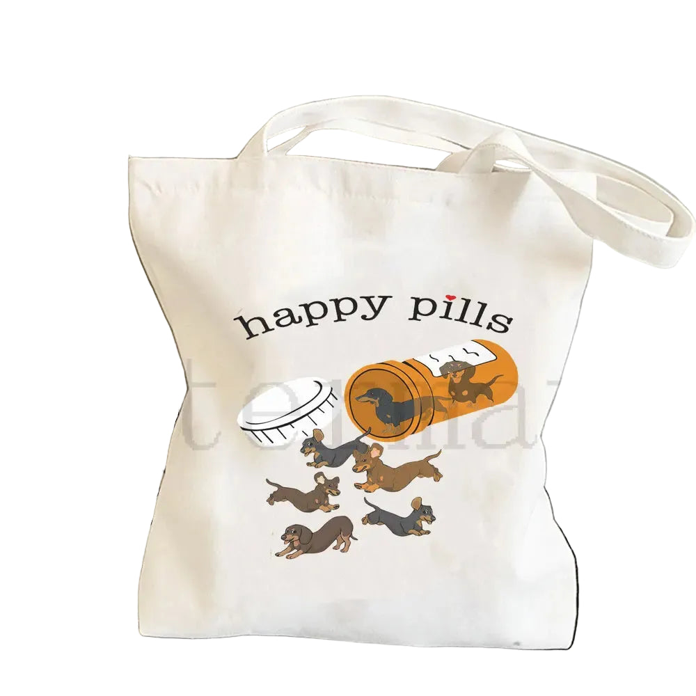 Cream canvas tote bag featuring playful Dachshunds spilling from a pill bottle with the words Happy Pills