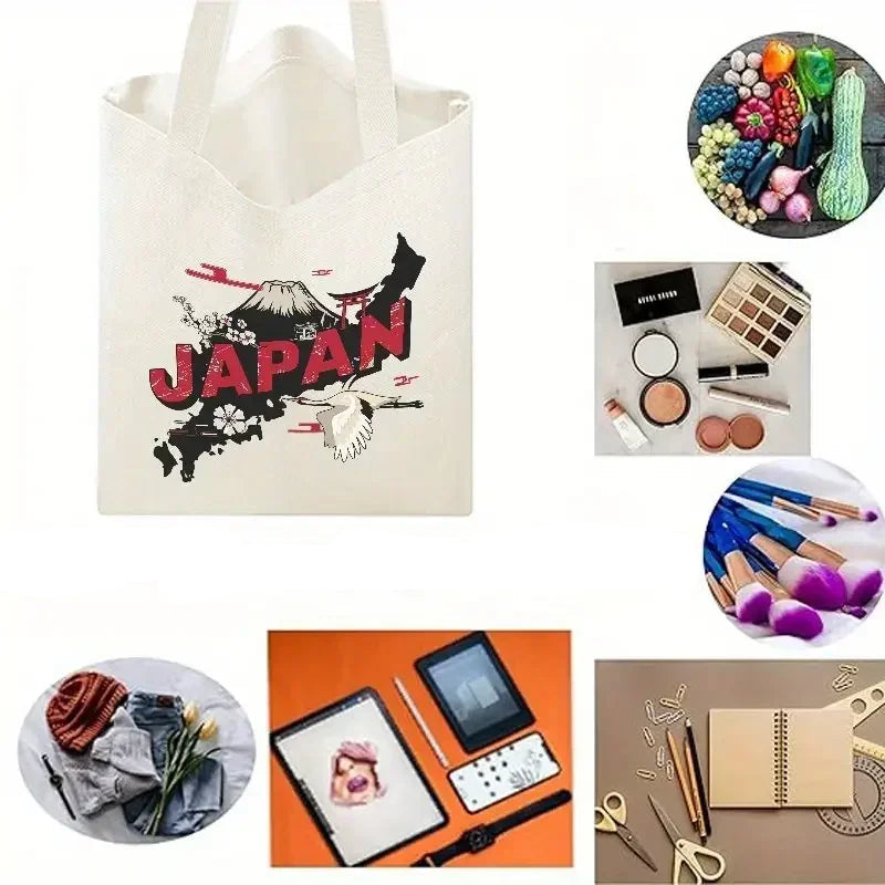 Cream canvas tote bag with Japan graphic shown alongside groceries, makeup, art supplies and everyday essentials
