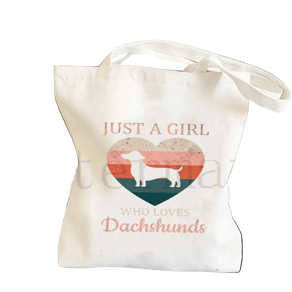 Cream canvas tote bag featuring a Dachshund silhouette inside a retro heart with the phrase Just a Girl Who Loves Dachshunds