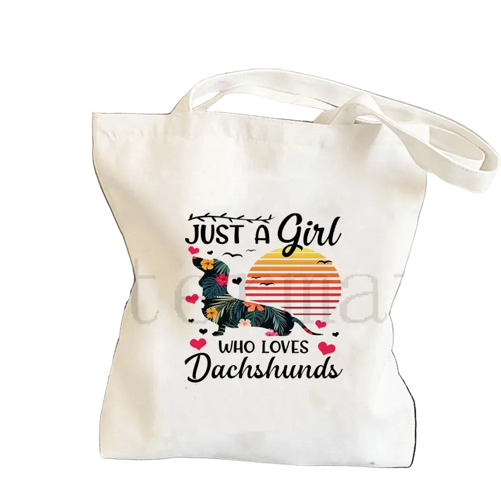 Cream canvas tote bag featuring a Dachshund graphic with floral details and the phrase Just a Girl Who Loves Dachshunds
