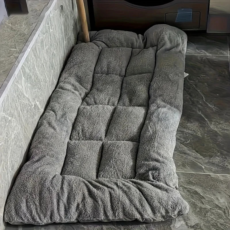 Large grey plush dog bed with thick raised cushioned sides and padded sleeping surface