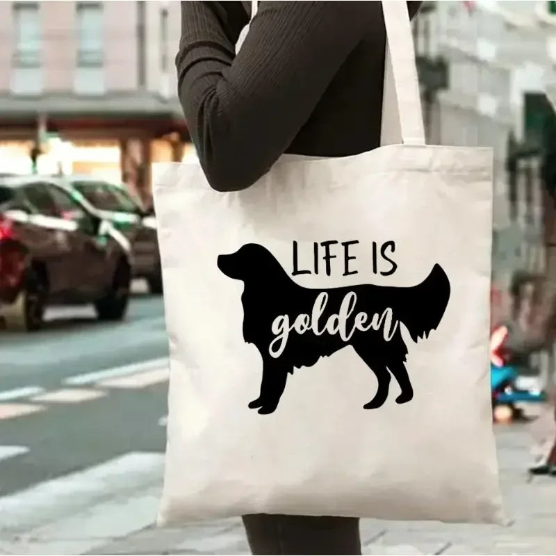 Cream canvas tote bag featuring a black Golden Retriever silhouette with the phrase Life Is Golden