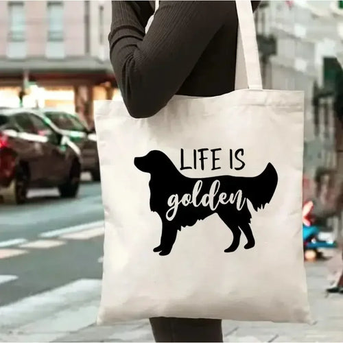 Cream canvas tote bag featuring eight illustrated Golden Retriever dogs in different coat shades