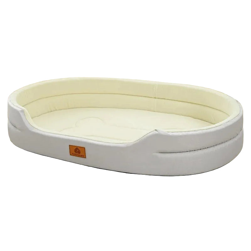 Light grey oval dog bed with cream padded interior, raised sides and a low front entry