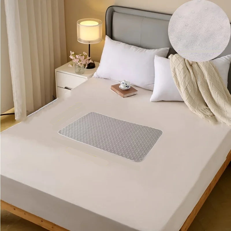 Light grey quilted dog bed mat with a padded diamond-pattern surface placed on a bedroom bed
