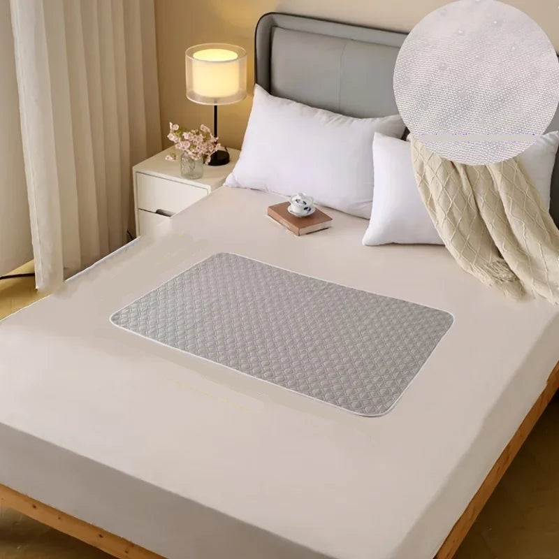 Light grey quilted dog bed mat with a padded diamond-pattern surface placed on a bedroom bed