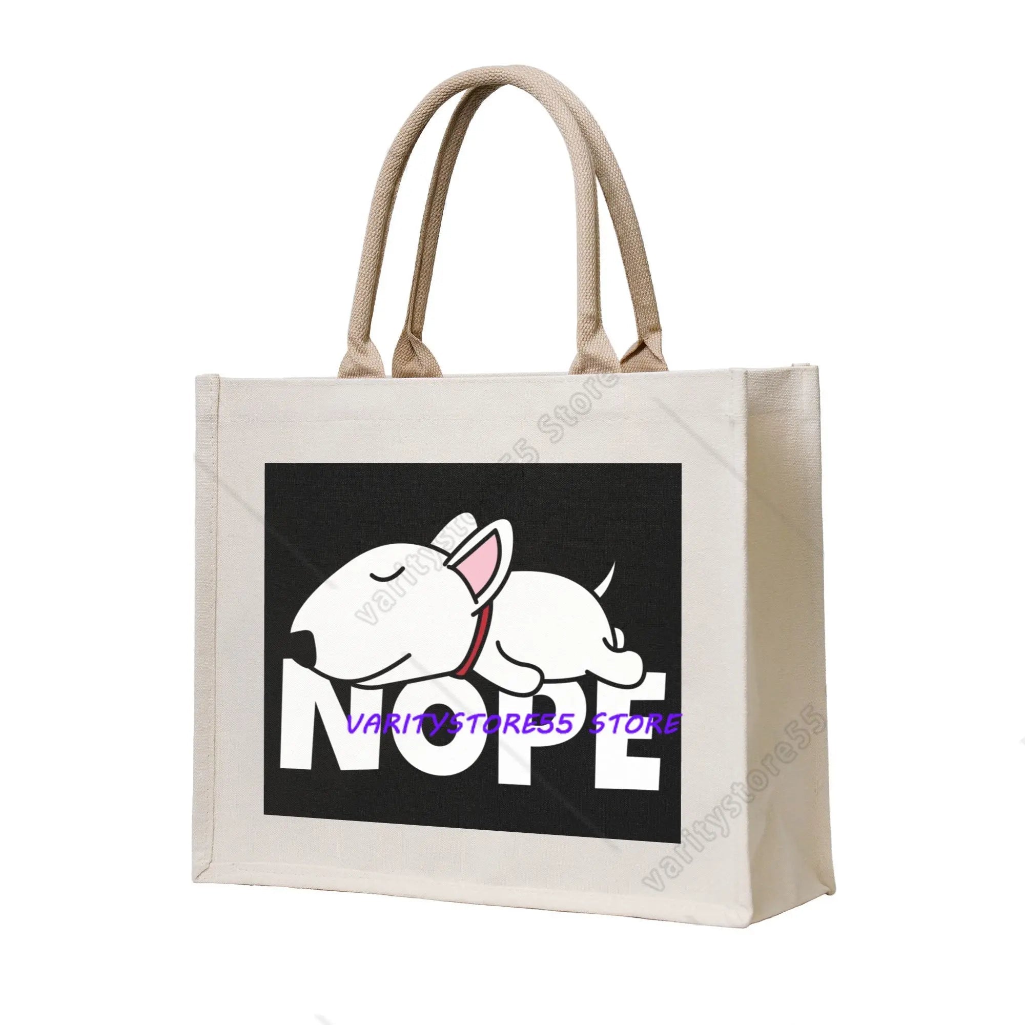 Cream canvas tote bag featuring a cartoon white Bull Terrier above the word Nope on a black background