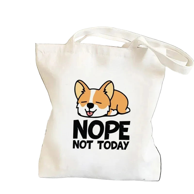 Cream canvas tote bag featuring a resting cartoon Corgi with the words Nope Not Today