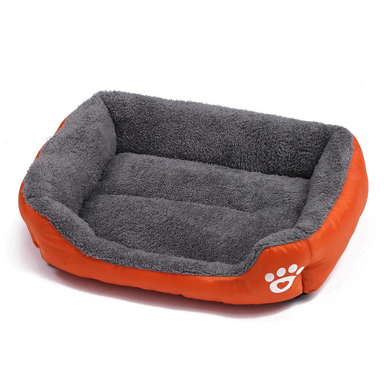 Orange and grey plush bolster dog bed with soft padded base, raised cushioned sides and paw print detail