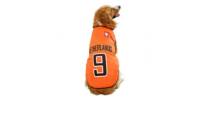 Golden-coloured dog wearing an orange Netherlands football jersey with number 9 printed on the back