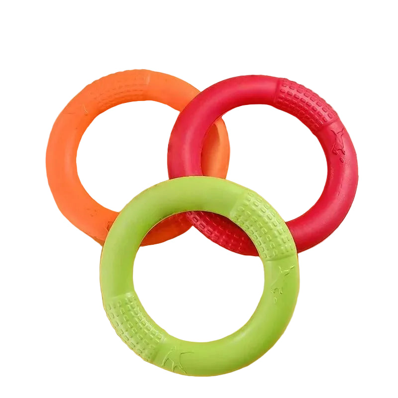 Orange, pink and green ring-shaped dog chew toys with textured grip sections for chewing and interactive play
